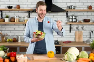 Man enjoying a fresh vegetable salad – healthy foods that increase energy naturally